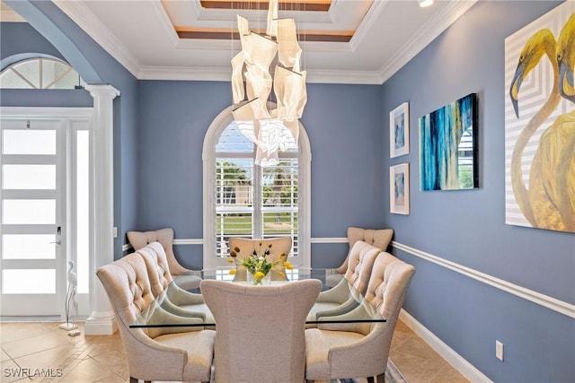 dining area featuring tile patterned flooring, crown molding, a tray ceiling, arched walkways, and ornate columns