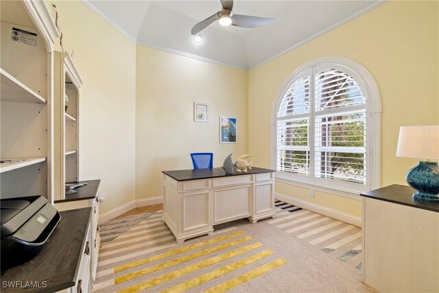 office space featuring ceiling fan, light colored carpet, vaulted ceiling, and crown molding