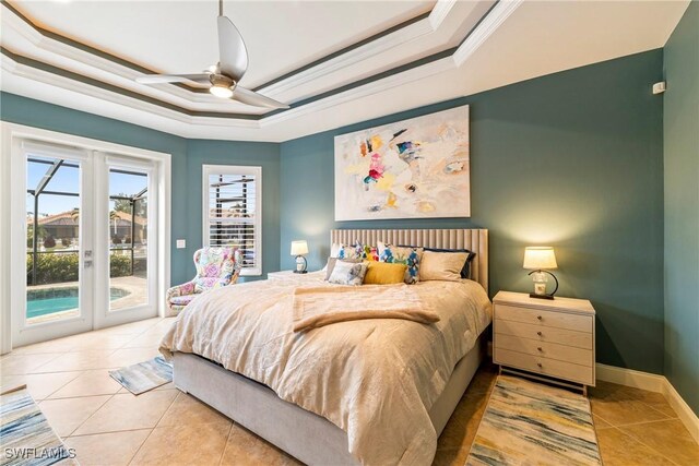 bedroom featuring access to exterior, ornamental molding, ceiling fan, light tile patterned floors, and a tray ceiling