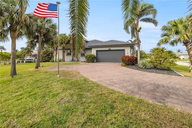 view of front of home with stucco siding, an attached garage, decorative driveway, and a front yard