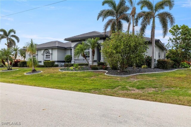 view of front of home with a porch and a front yard