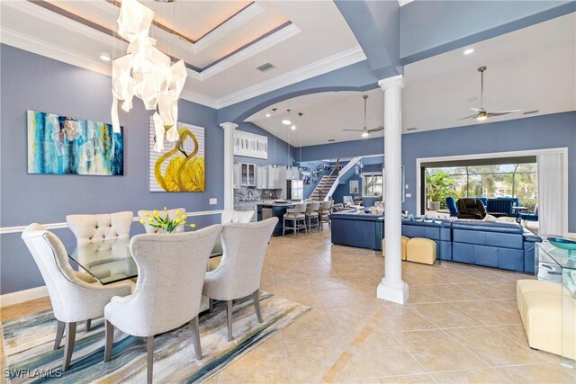 dining space featuring ornate columns, light tile patterned flooring, crown molding, and ceiling fan