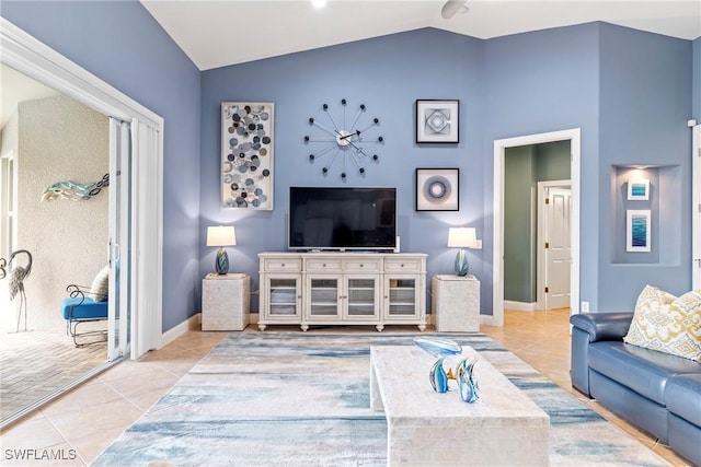 living room with tile patterned flooring, vaulted ceiling, and baseboards