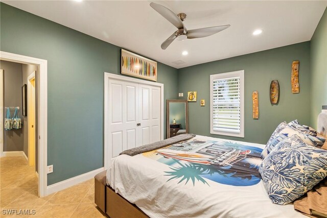 tiled bedroom featuring ceiling fan and a closet