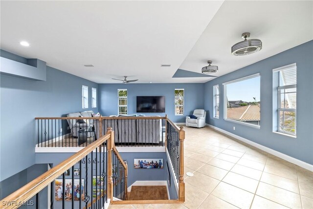 rec room with ceiling fan and light tile patterned floors