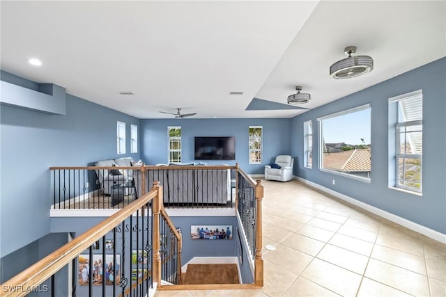 interior space featuring tile patterned flooring, visible vents, ceiling fan, and baseboards