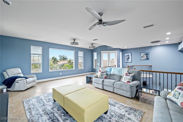 cinema featuring ceiling fan and light tile patterned floors