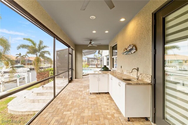 exterior space featuring a sink, area for grilling, and a ceiling fan