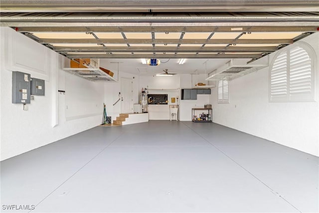 garage with electric panel and a garage door opener