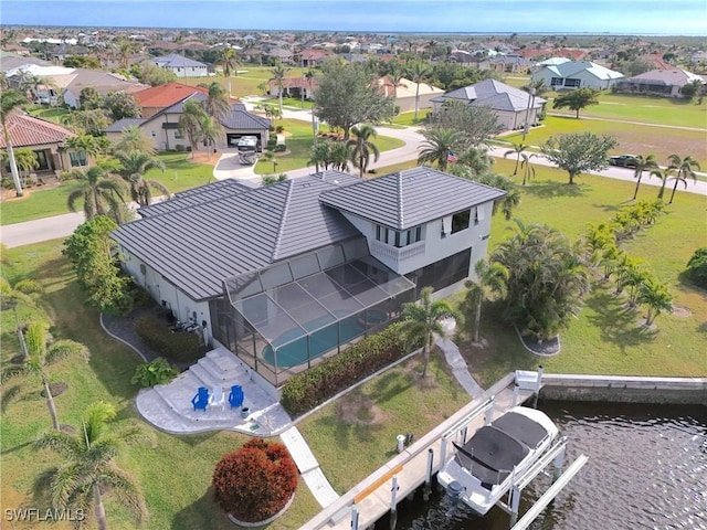 birds eye view of property featuring a residential view and a water view