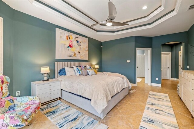 tiled bedroom featuring ceiling fan, ornamental molding, and a raised ceiling