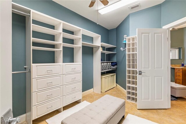 spacious closet featuring ceiling fan and light tile patterned flooring