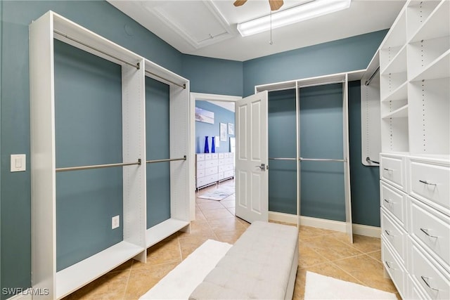 spacious closet with ceiling fan and light tile patterned flooring