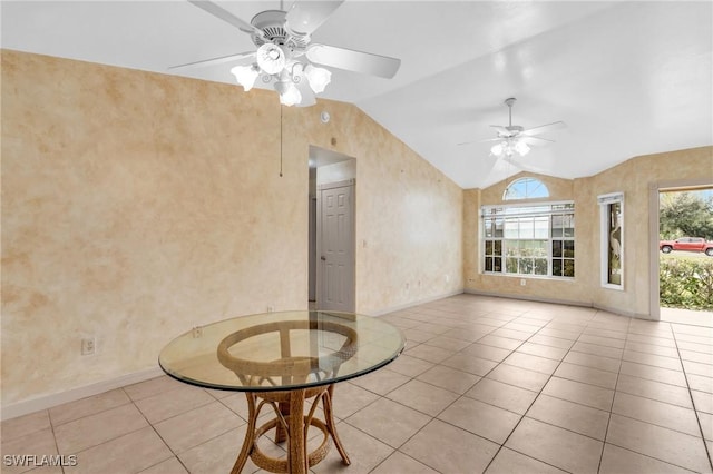 unfurnished living room with ceiling fan, light tile patterned floors, and vaulted ceiling