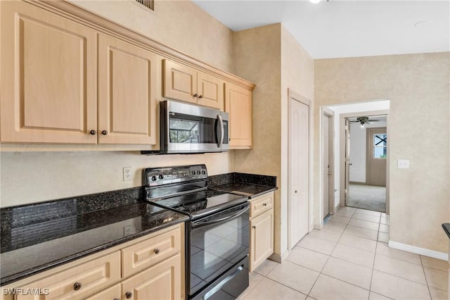 kitchen with light brown cabinets, black range with electric stovetop, dark stone counters, ceiling fan, and light tile patterned floors