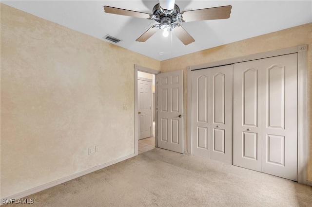 unfurnished bedroom with ceiling fan, a closet, and light colored carpet