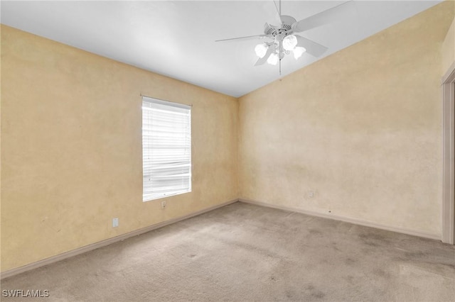 empty room with ceiling fan and light colored carpet