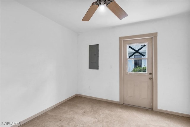 carpeted spare room featuring ceiling fan and electric panel