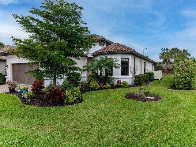 view of home's exterior with a garage and a lawn