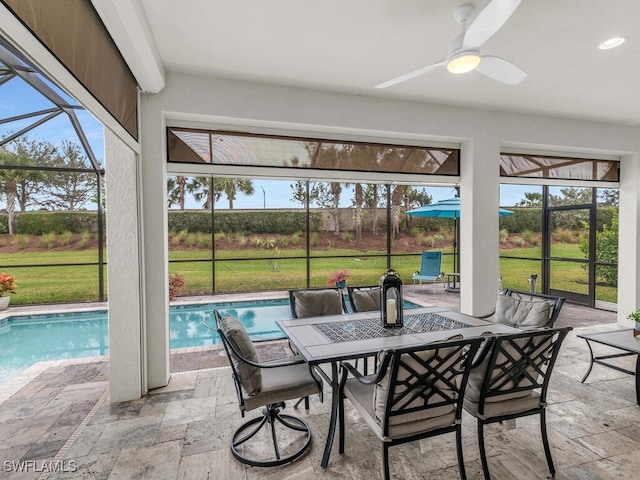 sunroom with a pool, plenty of natural light, and a ceiling fan