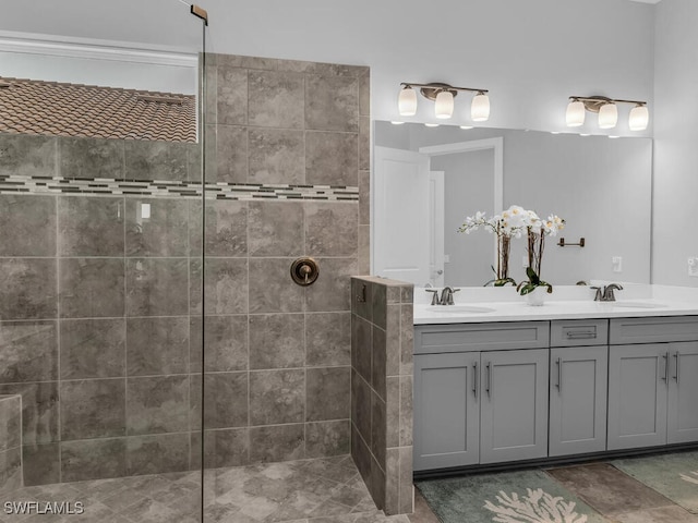 full bathroom with double vanity, a walk in shower, and a sink