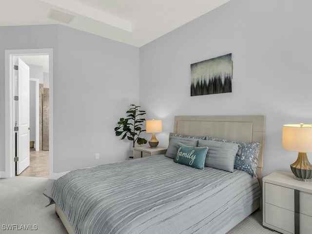 carpeted bedroom featuring visible vents