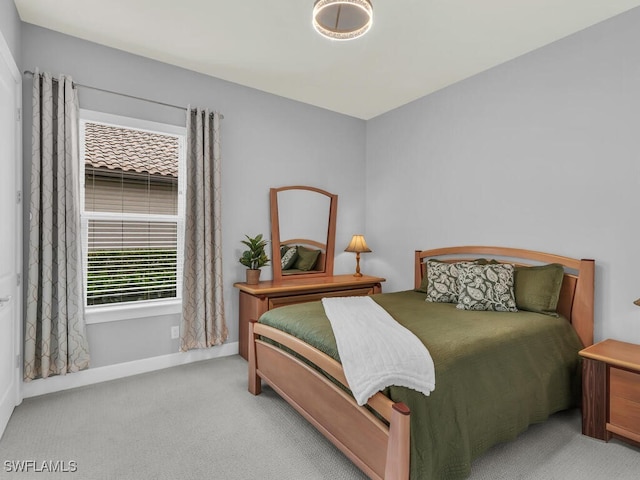 bedroom with baseboards and carpet floors