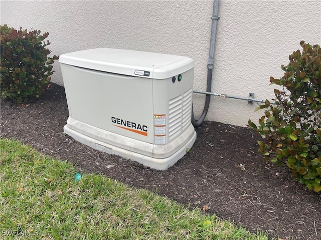 exterior details featuring stucco siding and a power unit