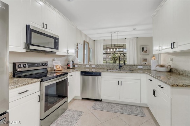 kitchen featuring light stone countertops, white cabinetry, stainless steel appliances, sink, and kitchen peninsula