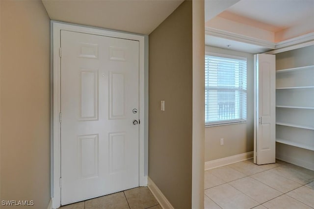 doorway with light tile patterned floors