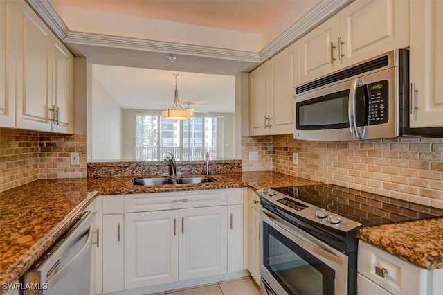 kitchen featuring decorative backsplash, sink, white cabinets, and stainless steel appliances