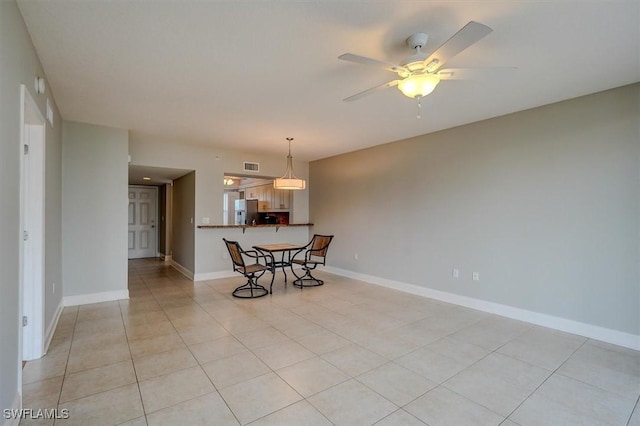 tiled empty room with ceiling fan