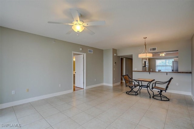 tiled dining area featuring ceiling fan