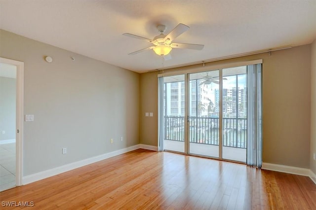 spare room featuring light wood-type flooring and ceiling fan