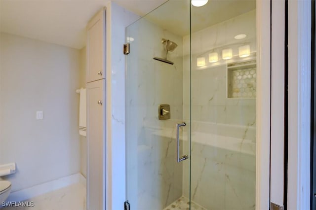 bathroom featuring toilet and walk in shower