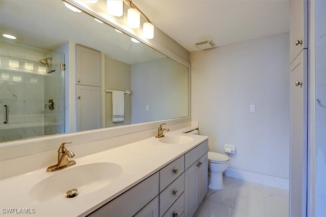 bathroom with vanity, toilet, tile patterned floors, and a shower with door