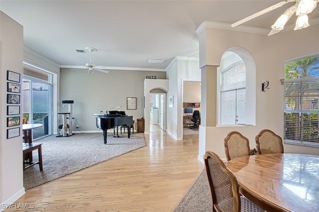 dining room with ceiling fan, light hardwood / wood-style flooring, and crown molding