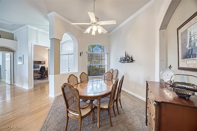 dining space with light wood-type flooring, ceiling fan, and ornamental molding