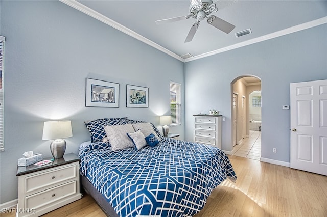 bedroom with ceiling fan, connected bathroom, ornamental molding, and multiple windows