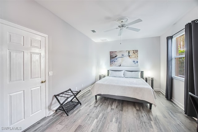 bedroom with ceiling fan and light hardwood / wood-style flooring