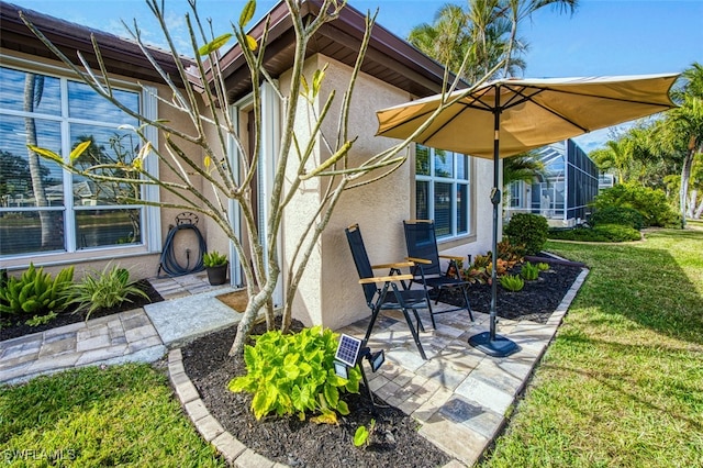 exterior space featuring a lanai, a yard, and a patio