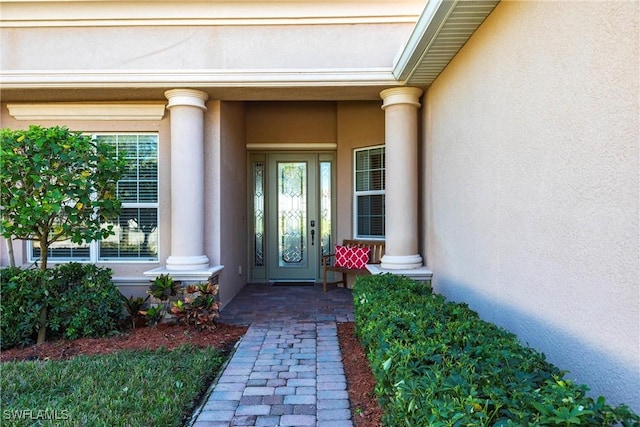 view of exterior entry with stucco siding