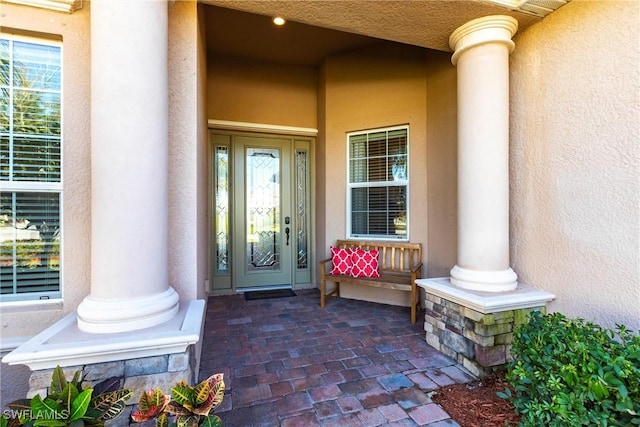 doorway to property with stucco siding