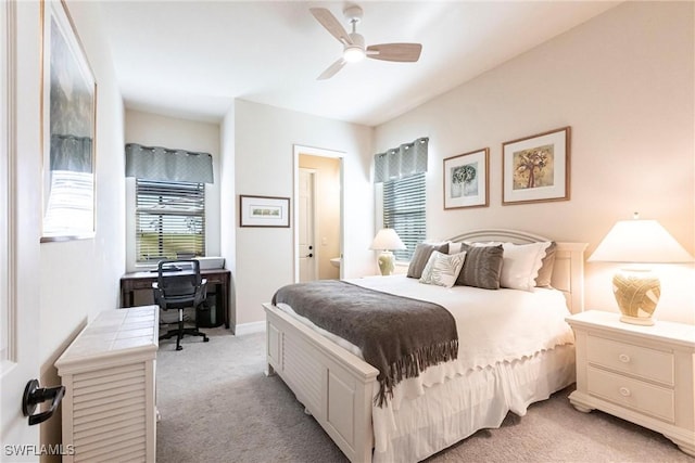 bedroom with light colored carpet, baseboards, and ceiling fan