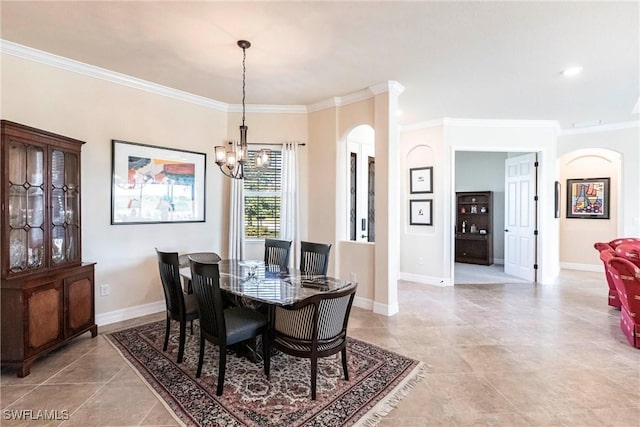 dining room with a notable chandelier, ornamental molding, arched walkways, light tile patterned floors, and baseboards