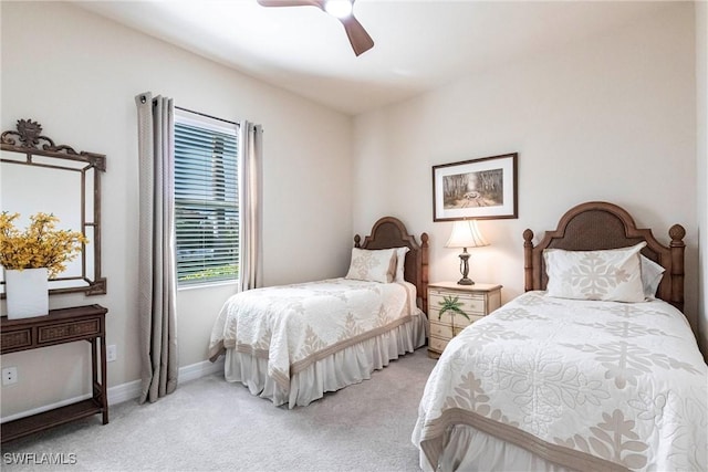 bedroom with light colored carpet, baseboards, and a ceiling fan