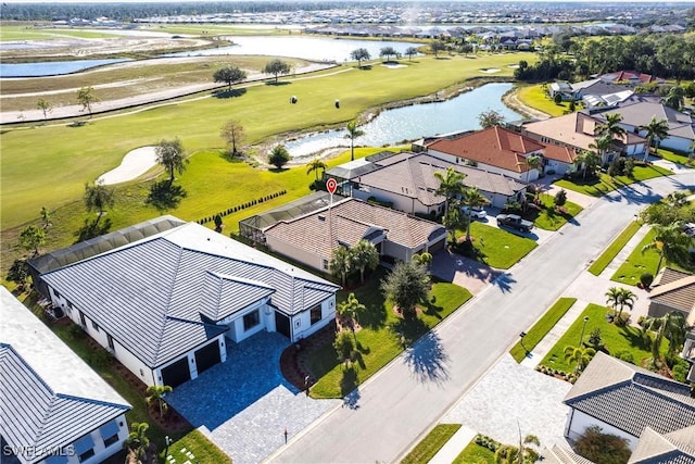 bird's eye view featuring a residential view, golf course view, and a water view