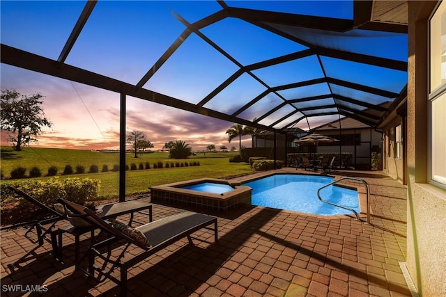 view of swimming pool featuring a lawn, a pool with connected hot tub, a patio, glass enclosure, and a rural view