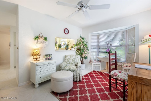 living area featuring light tile patterned flooring and ceiling fan