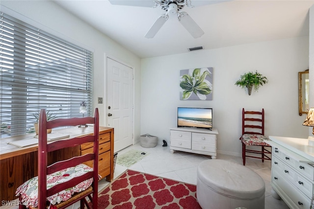 interior space with light tile patterned flooring and ceiling fan